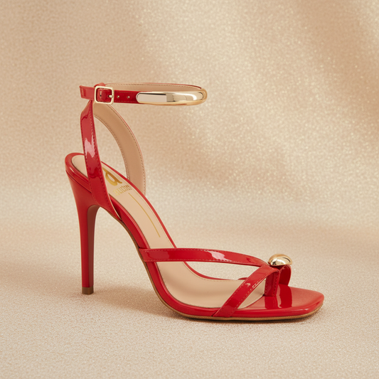 Red strappy heels on warm neutral background